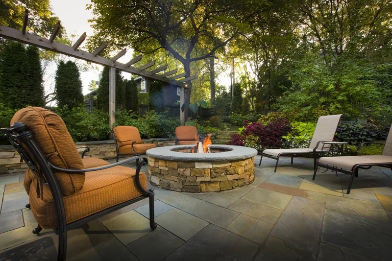 Fire pit terrace set within a planted backyard