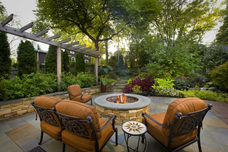 Custom fire pit gathering area with evening lighting