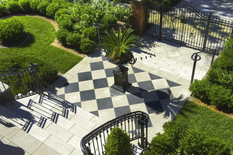 Patterned paver patio with outdoor seating and garden views