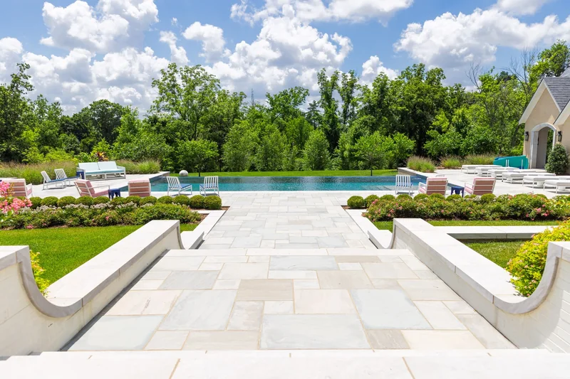 Formal paver terrace with outdoor dining and lounge areas