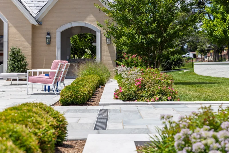 Custom paver patio approach with seat walls and planting beds