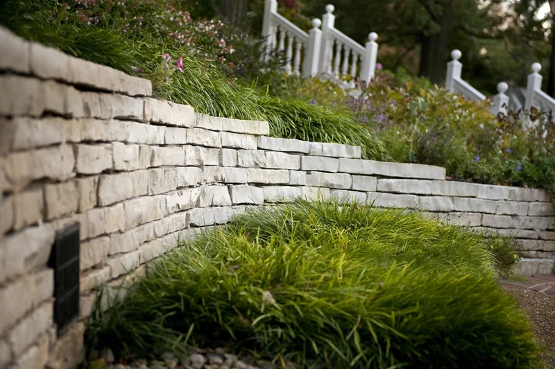 Retaining wall and steps integrated into a pool landscape